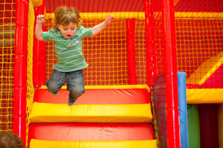 Kid Jumping In Play Area