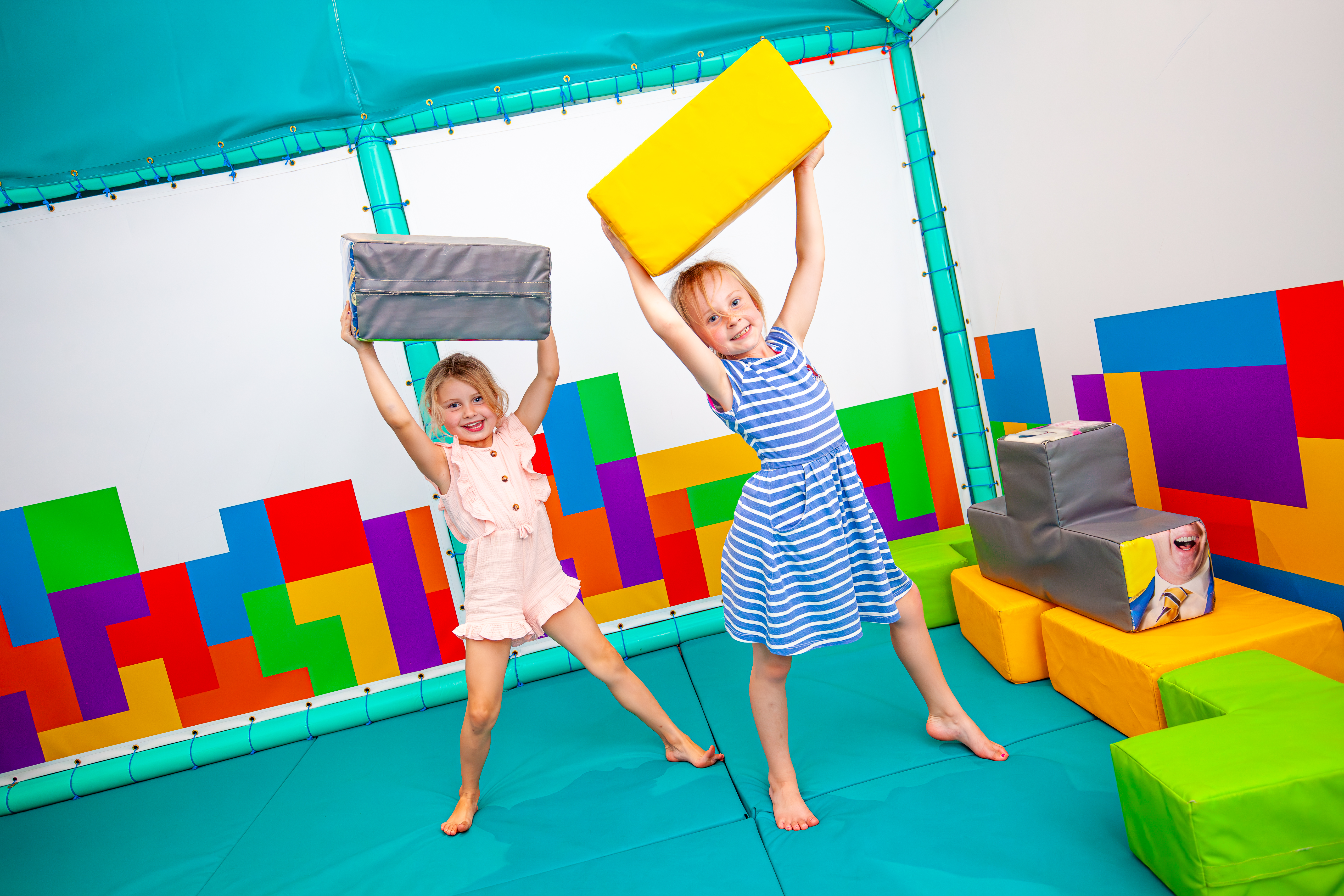 Two young girls playing with Tetris like soft play at Sooty Land