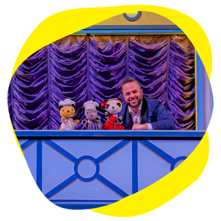And image of Sooty Sweep and soo live on stage with a presenter