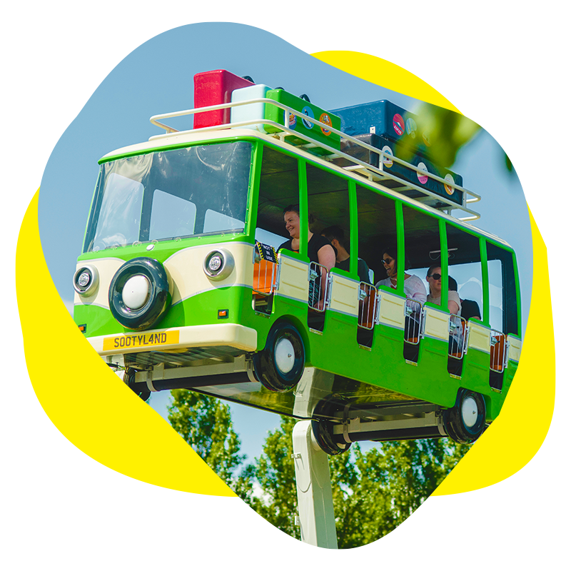 An image of a magic bus ride in the air at a theme park with blue skies 